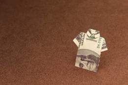 hundred dollar bill folded into shirt shape